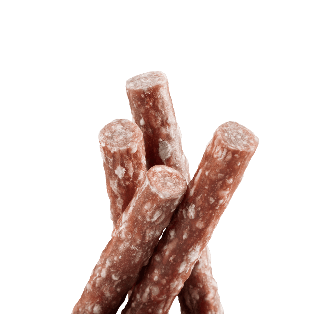 Three chocolate-covered pretzel sticks on a black background